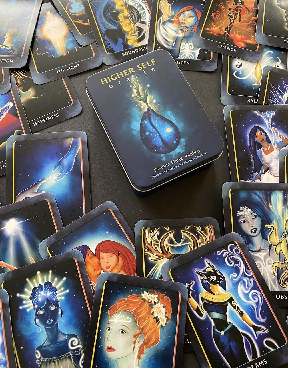 Collection of tarot cards with artistic designs on a dark surface