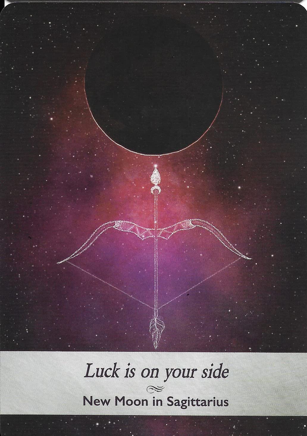 Astrological card with a bow and arrow design and text 'Luck is on your side New Moon in Sagittarius' against a starry night sky background.