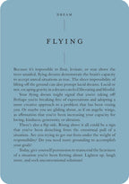 A text-based card or poster with a muted blue background and black text, headed 'DREAM' and 'FLYING,' followed by a paragraph of explanatory dream-interpretation text.