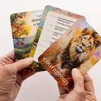 Talented hands holding a deck of tarot cards with a lion illustration on one card.