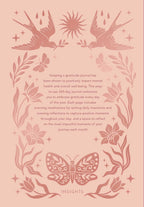 Decorative cover of a gratitude journal with floral and butterfly designs on a pink background.