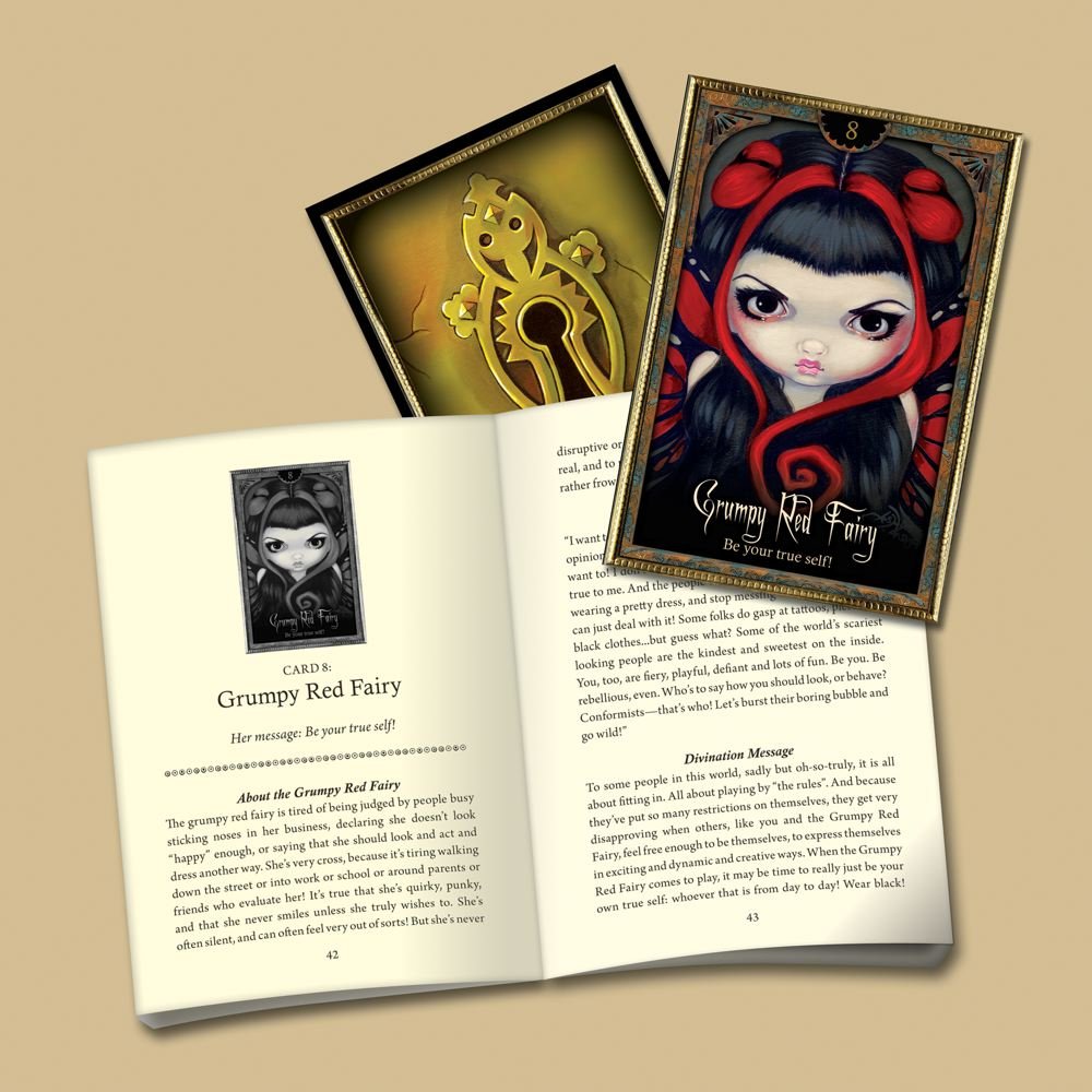 Open book with 'Grumpy Red Fairy' card and key illustration on a beige background