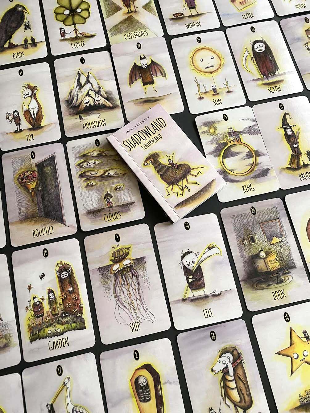 Collection of illustrated cards with various designs on a dark background