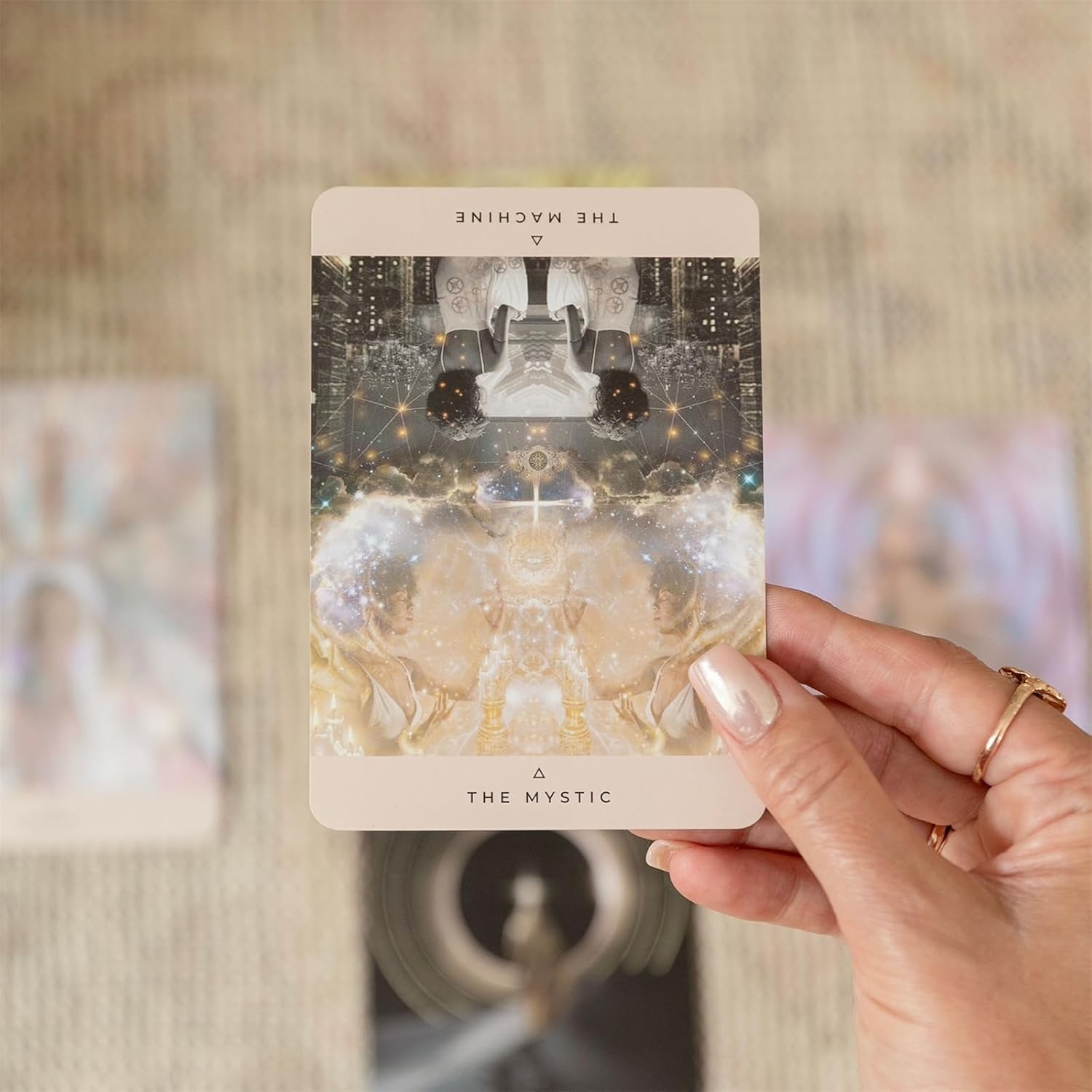 Hand holding a tarot card titled 'The Mystic' with a blurred background