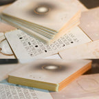 Stack of books with text and decorative elements on a wooden surface