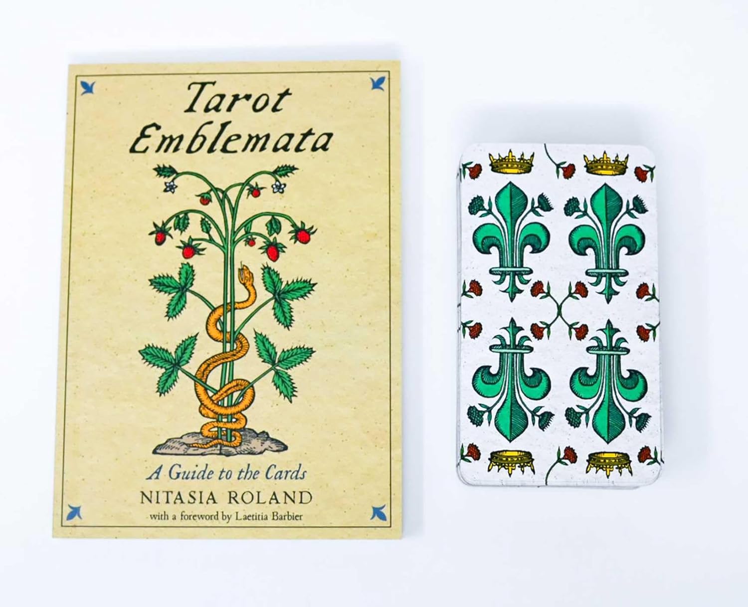 Book titled 'Tarot Emblemata' by Nitasia Roland with a tarot card featuring green emblem design on a white background.