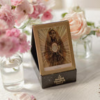 Oracular card from 'The Inner Temple Oracle' on a stand with pink flowers in the background.
