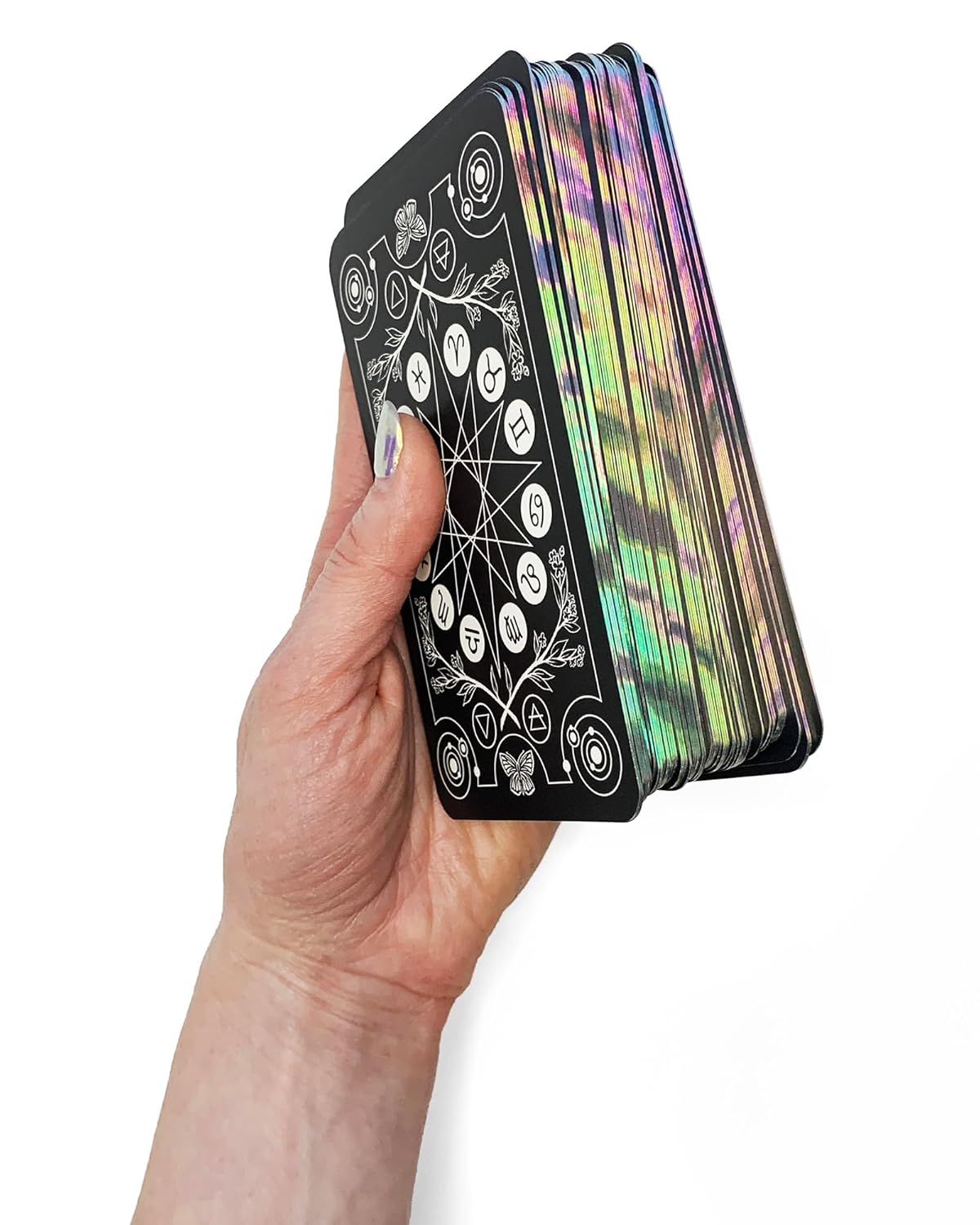 Hand holding a deck of tarot cards with colorful backings