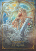 A fantasy-style illustrated card or poster titled "THE DREAMER -7-" shows a seated woman with long blonde hair in a dreamy interior with stained-glass-like windows, flowers, and a rose. The artwork is framed by an ornate gold border.