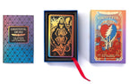 Grateful Dead official tarot deck and oracle book set shown on a white background, including a patterned box, an open deck box with a skeleton card, and the oracle book with a red ribbon.