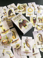Collection of tarot cards with a central box labeled 'Shadowland Lenormand' on a dark surface.
