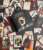 Collection of playing cards with detailed artwork and a book titled 'The Doors of Sidheith' on a dark surface.