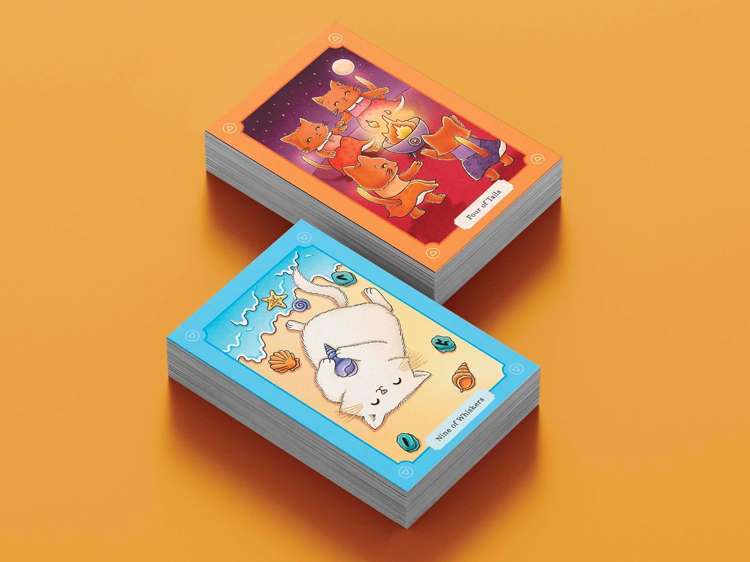 Two stacks of illustrated cards on an orange background