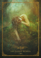 A tarot-style card illustration titled 'THE PASSIVE WOMAN - 39 -' with ornate gold border details. The central artwork shows a nude woman reclining on mossy ground in a misty forest-like setting with green and gold tones.