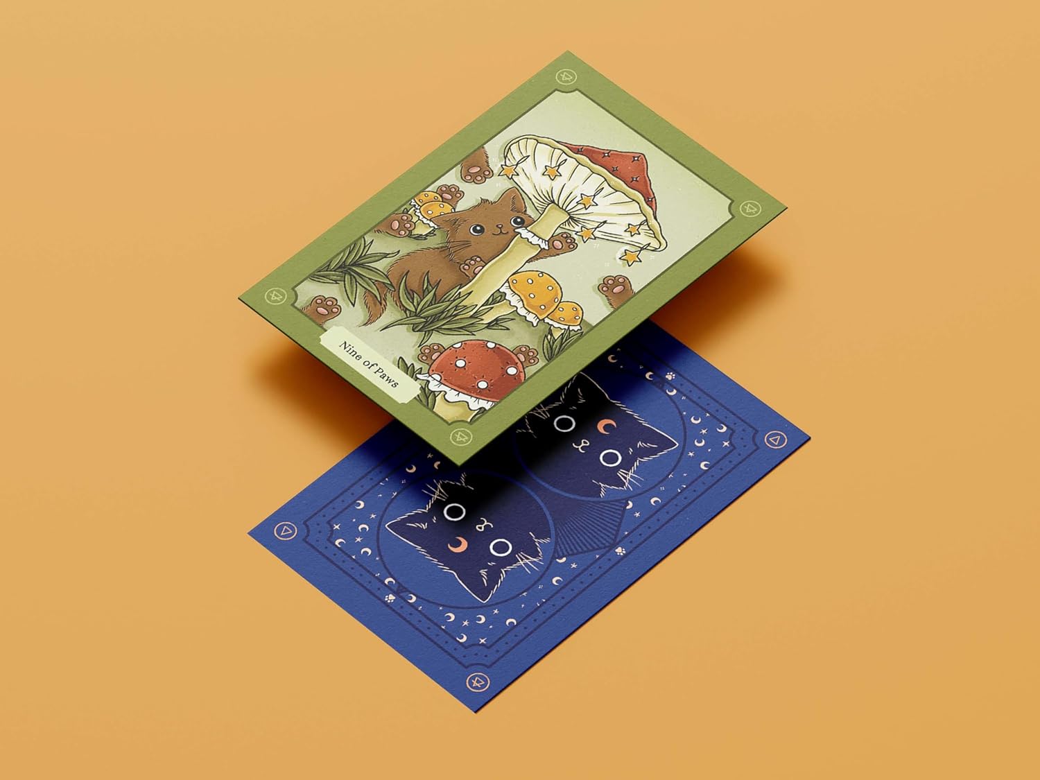 Two tarot cards on a beige background, one green with a bear and flowers, the other blue with cat illustrations.
