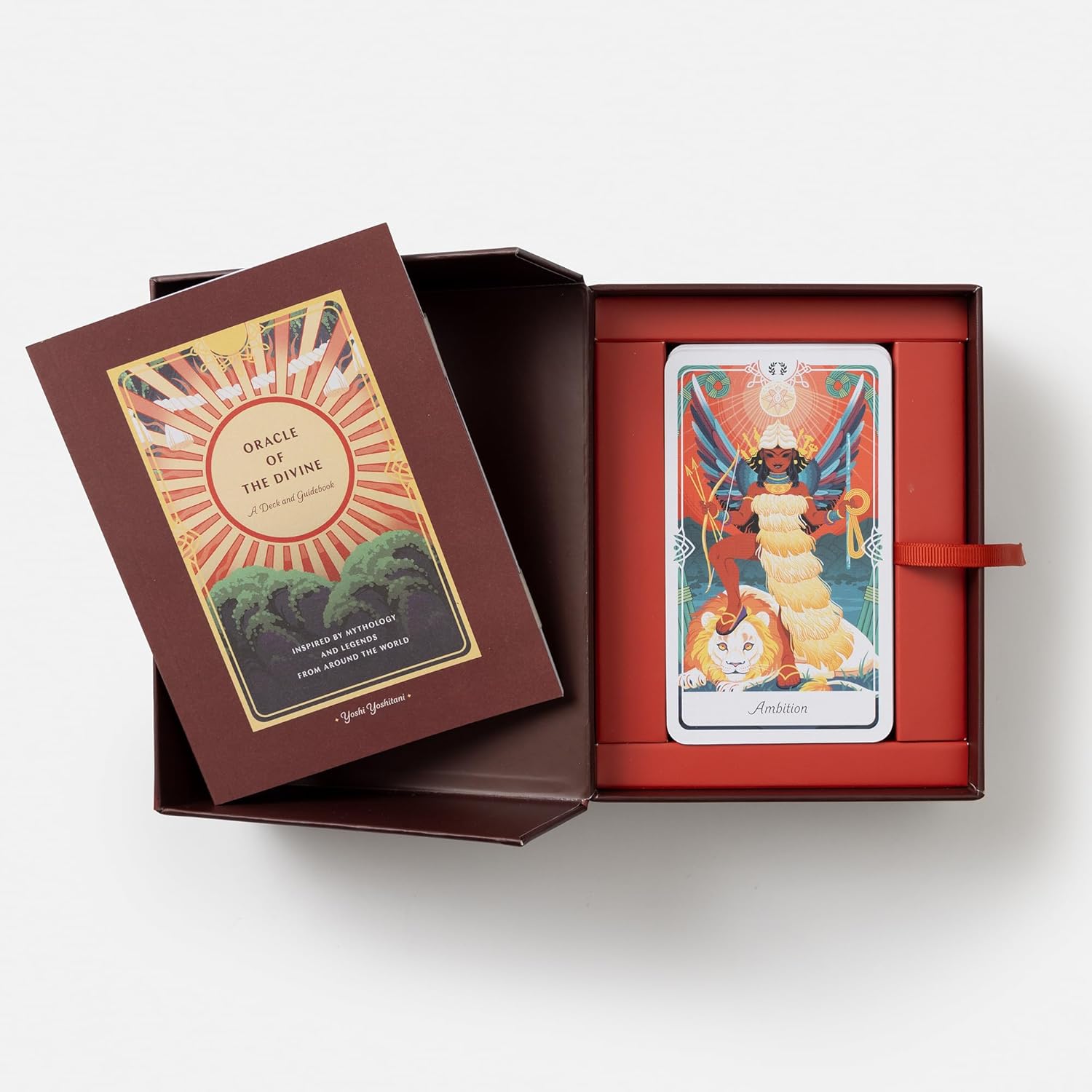 Open box containing Oracle of the Divine cards with a card displayed on a white background