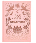 Pink journal titled '365 Days of Gratitude' with floral and bird designs on a white background
