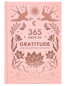Pink journal titled '365 Days of Gratitude' with floral and bird designs on a white background