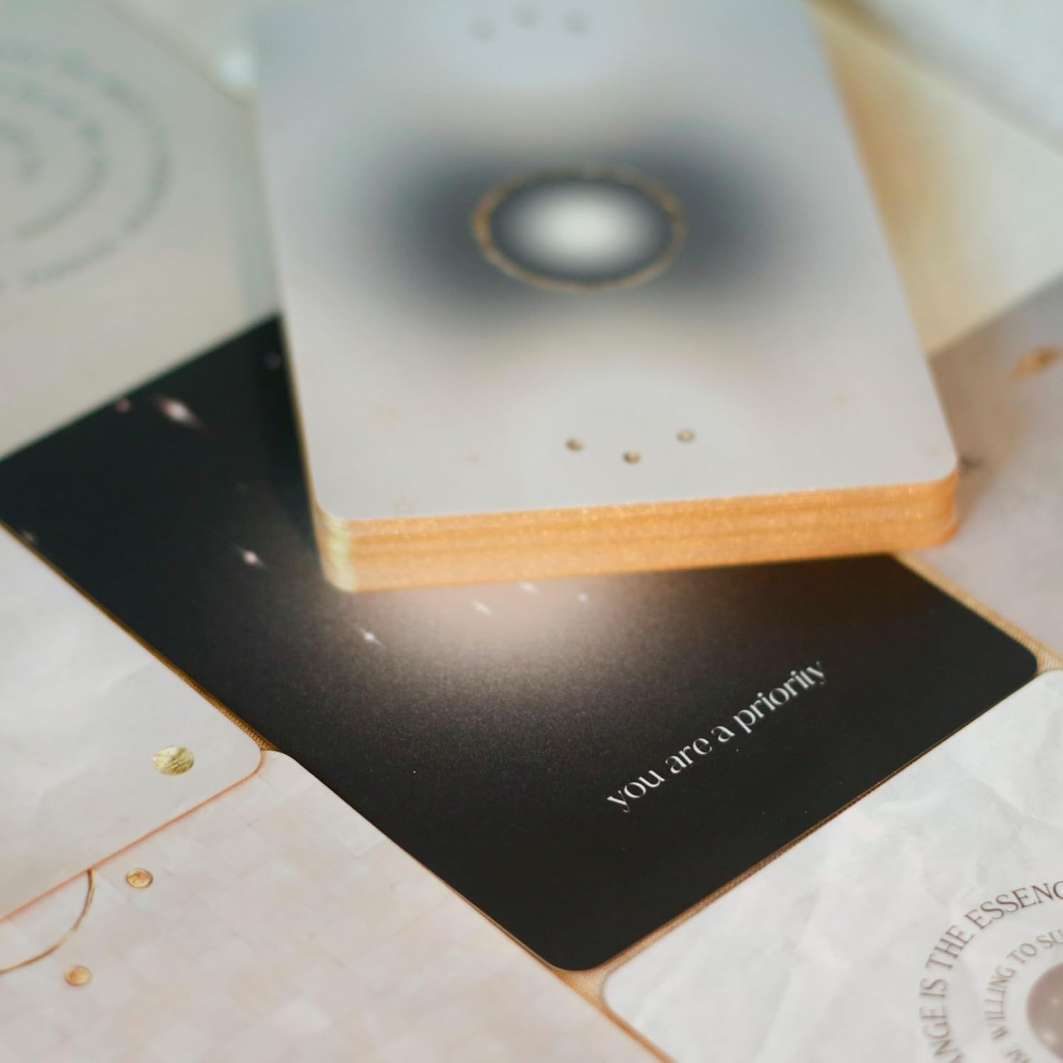 Close-up of a card with 'you are a priority' text on a textured surface.