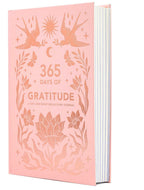 Pink journal titled '365 Days of Gratitude' with floral and bird designs on a white background