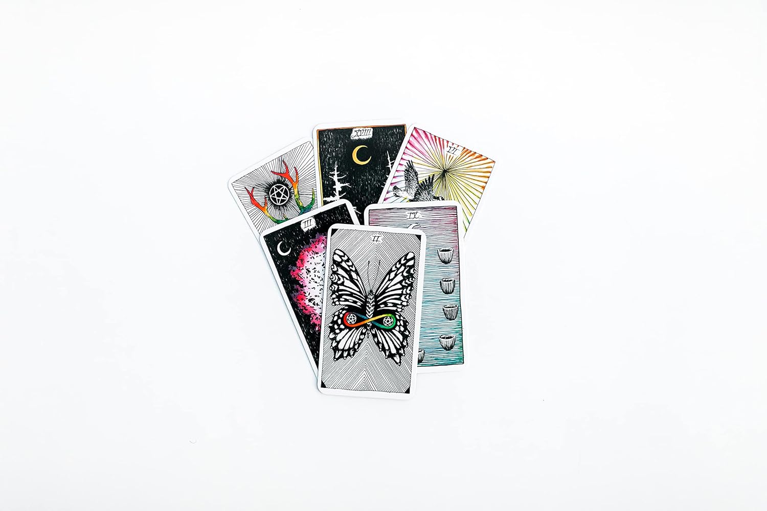 Collection of tarot cards with various designs on a white background