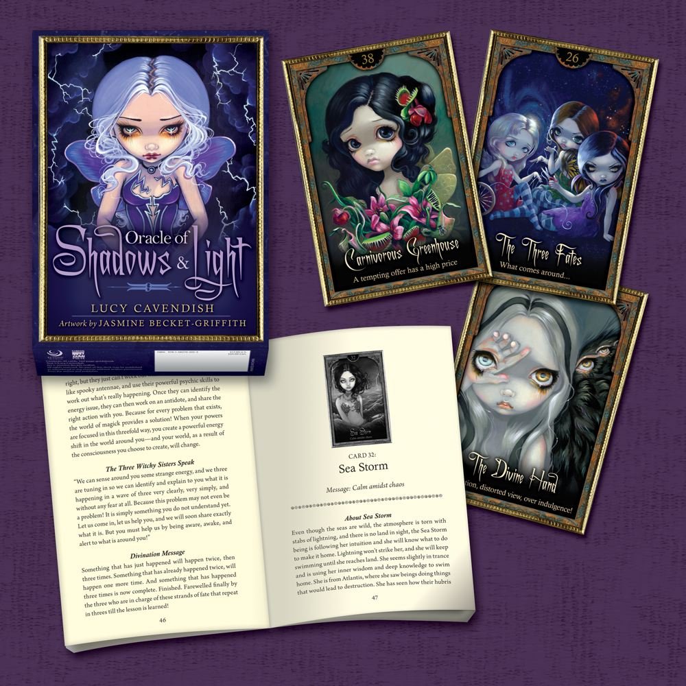 Oracle cards and book on a purple background