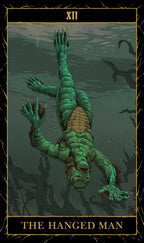 Tarot card featuring a green figure hanging by its feet with water and fish in the background.