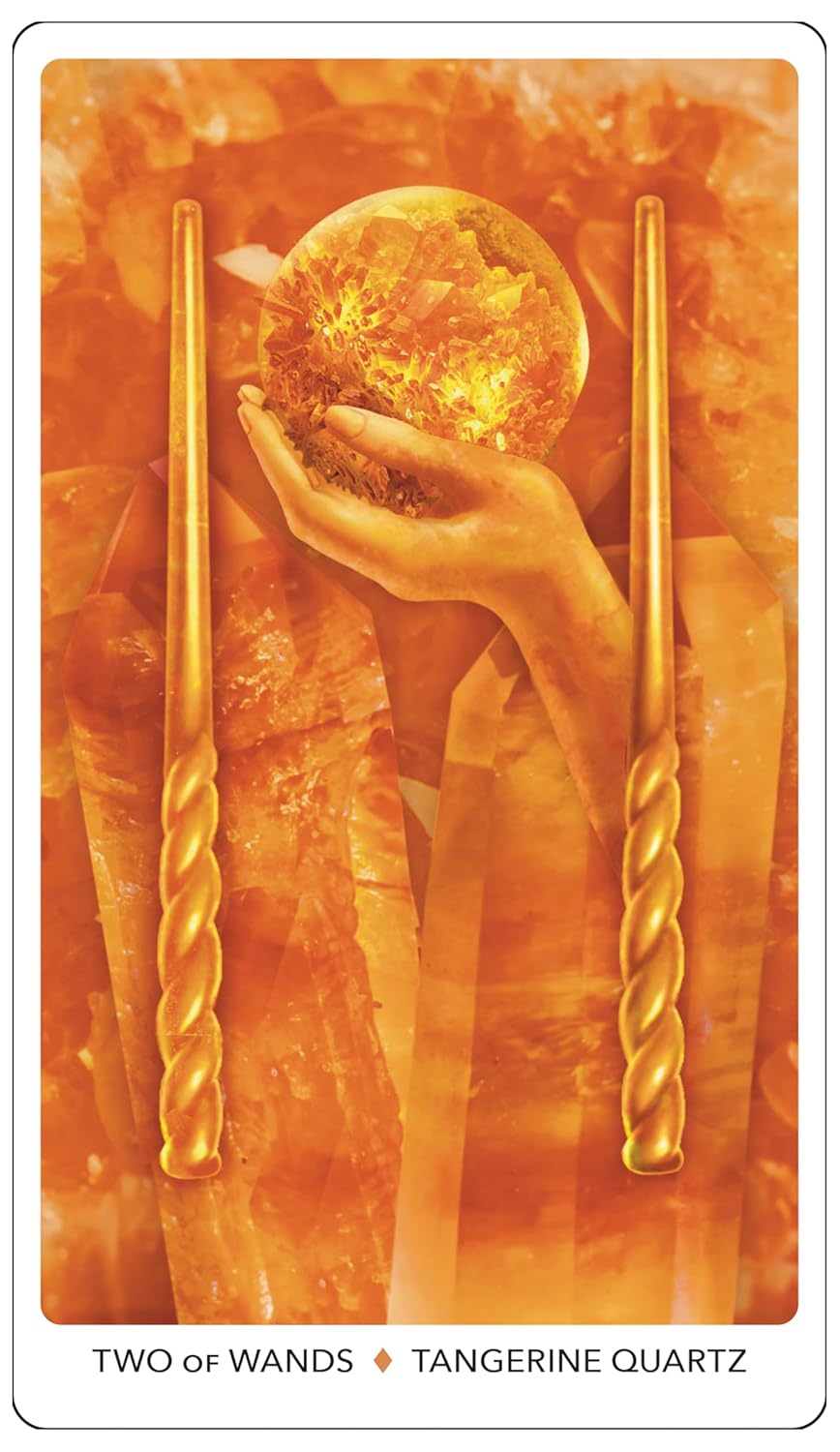 Two of Wands tarot card with a hand holding a crystal ball and two gold wands, featuring Tangerine Quartz.