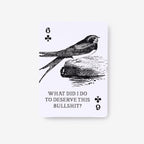 A single playing card shown upright on a light gray background. The card is white with black printed artwork of a bird perched on a log, with the text 'WHAT DID I DO TO DESERVE THIS BULLSHIT?' and playing card numbers and symbols.