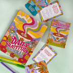 Colorful 'Daily Gratitude' journal and cards on a light green background