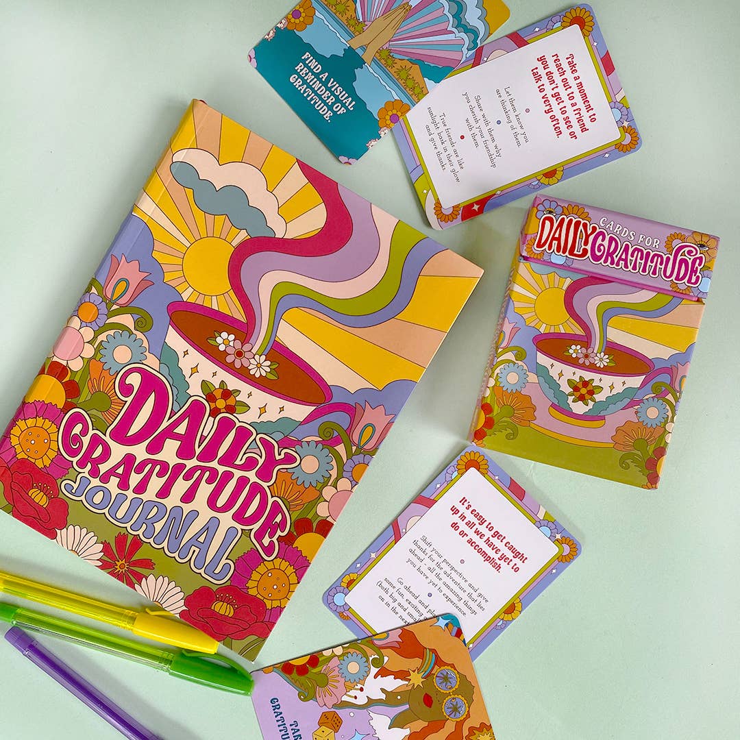 Colorful 'Daily Gratitude' journal and cards on a light green background