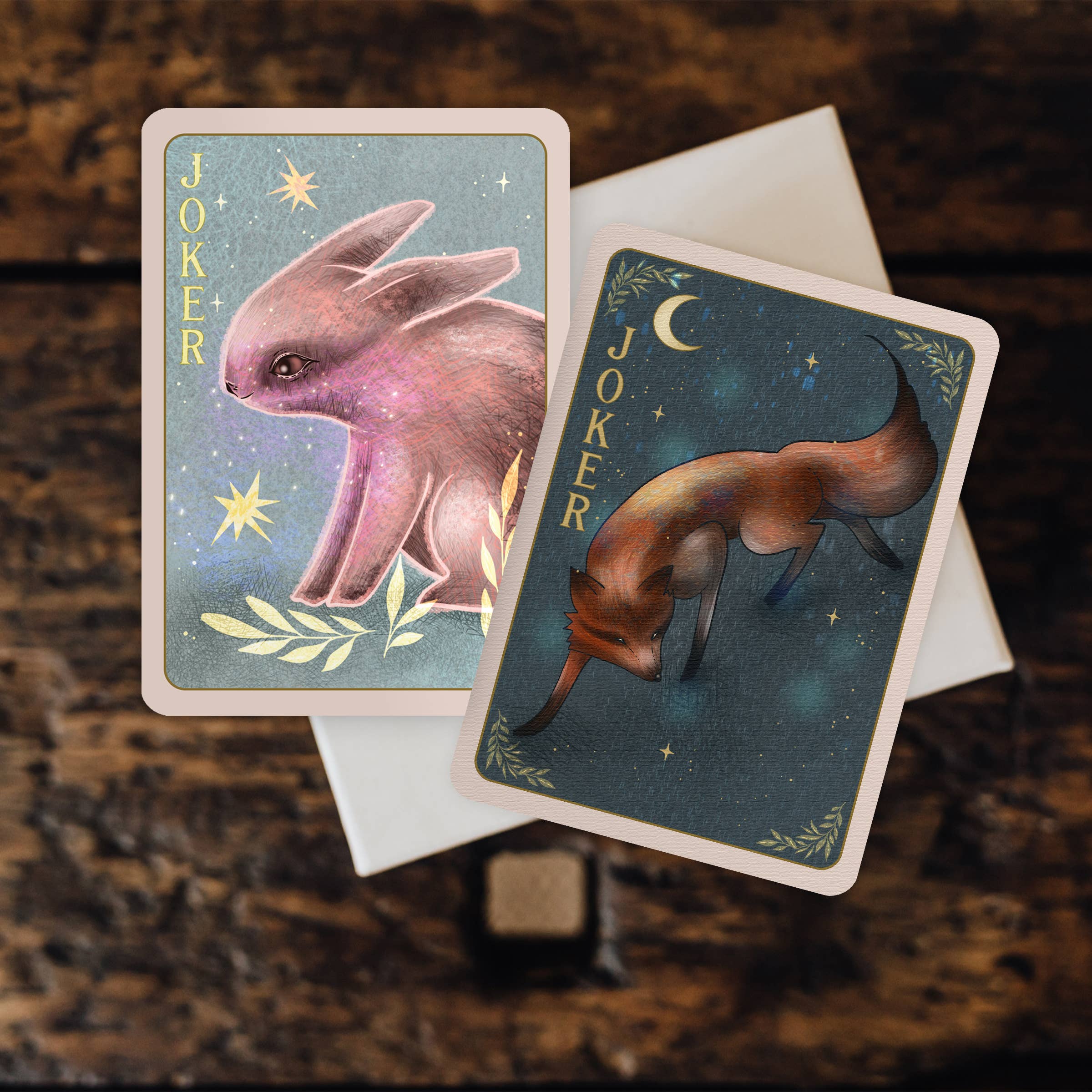 Two tarot cards featuring animal illustrations on a textured surface