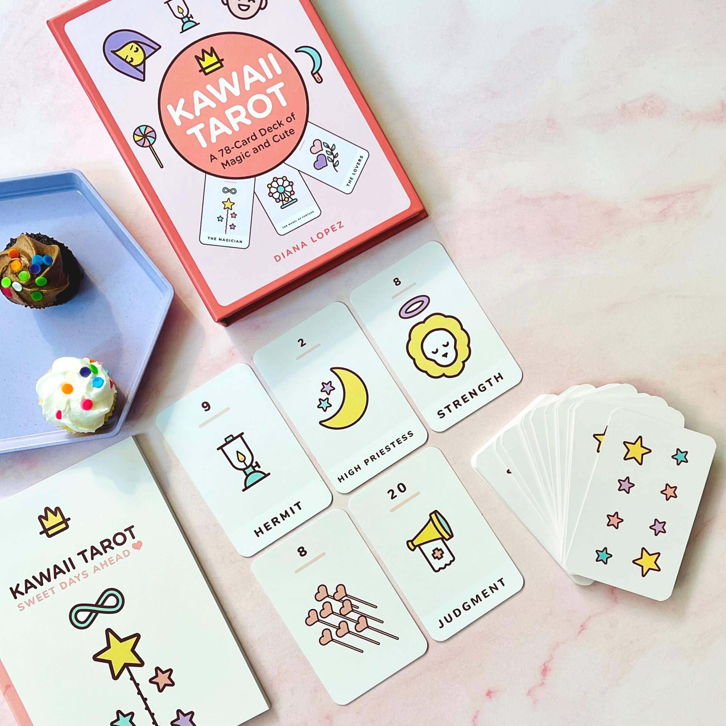 Kawaii Tarot card set with cards and box on a pink surface