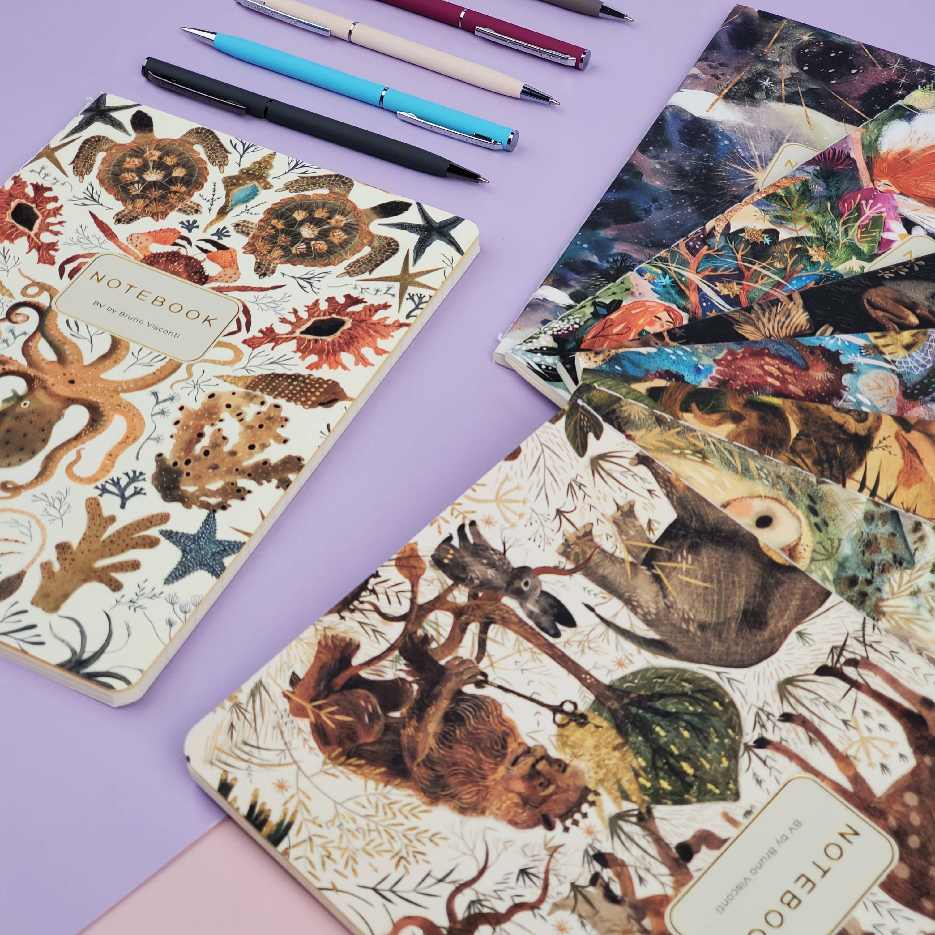 Notebooks with animal illustrations on a purple surface