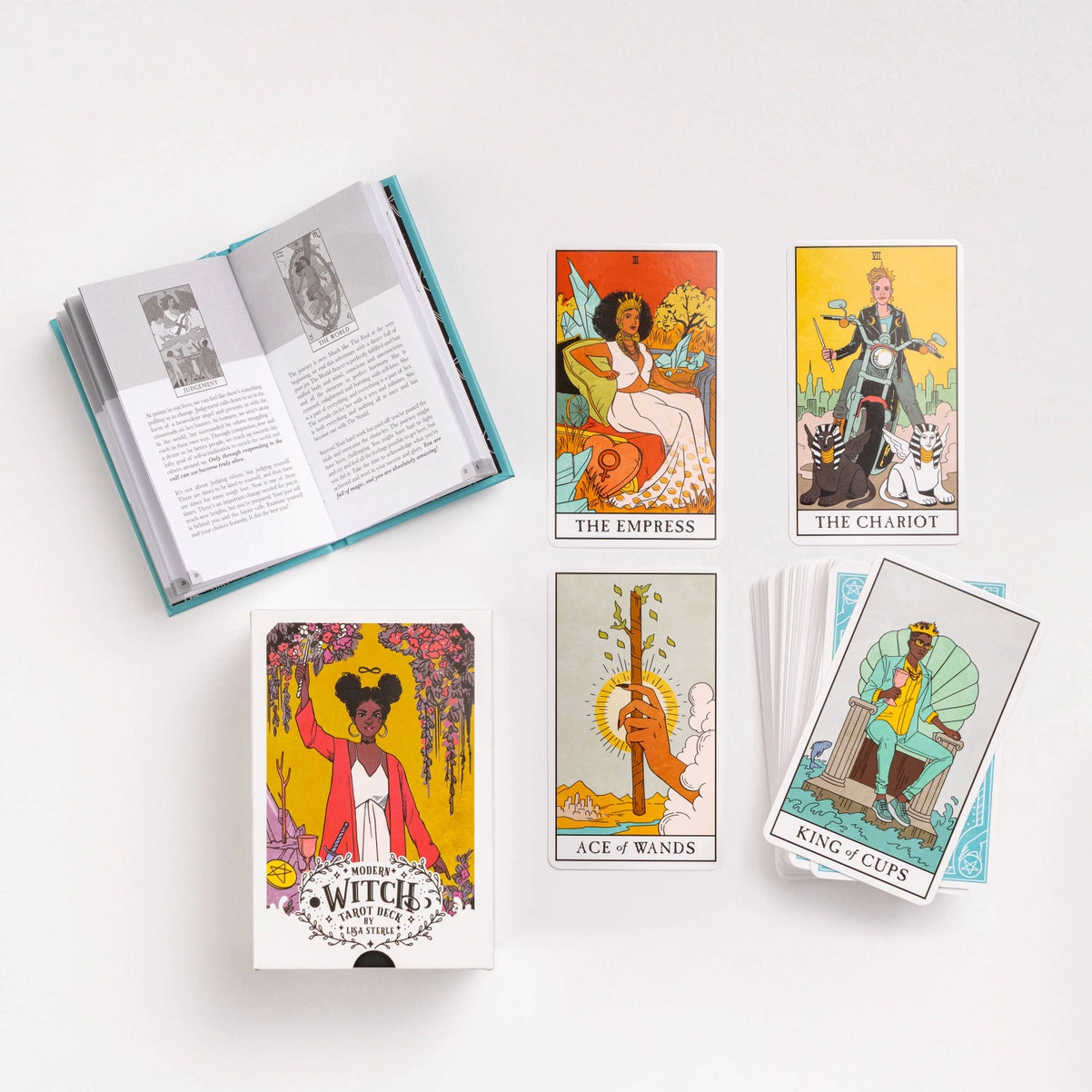 Collection of tarot cards and a book on a white background