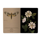 Notebook with butterfly design on beige page and floral design on black page