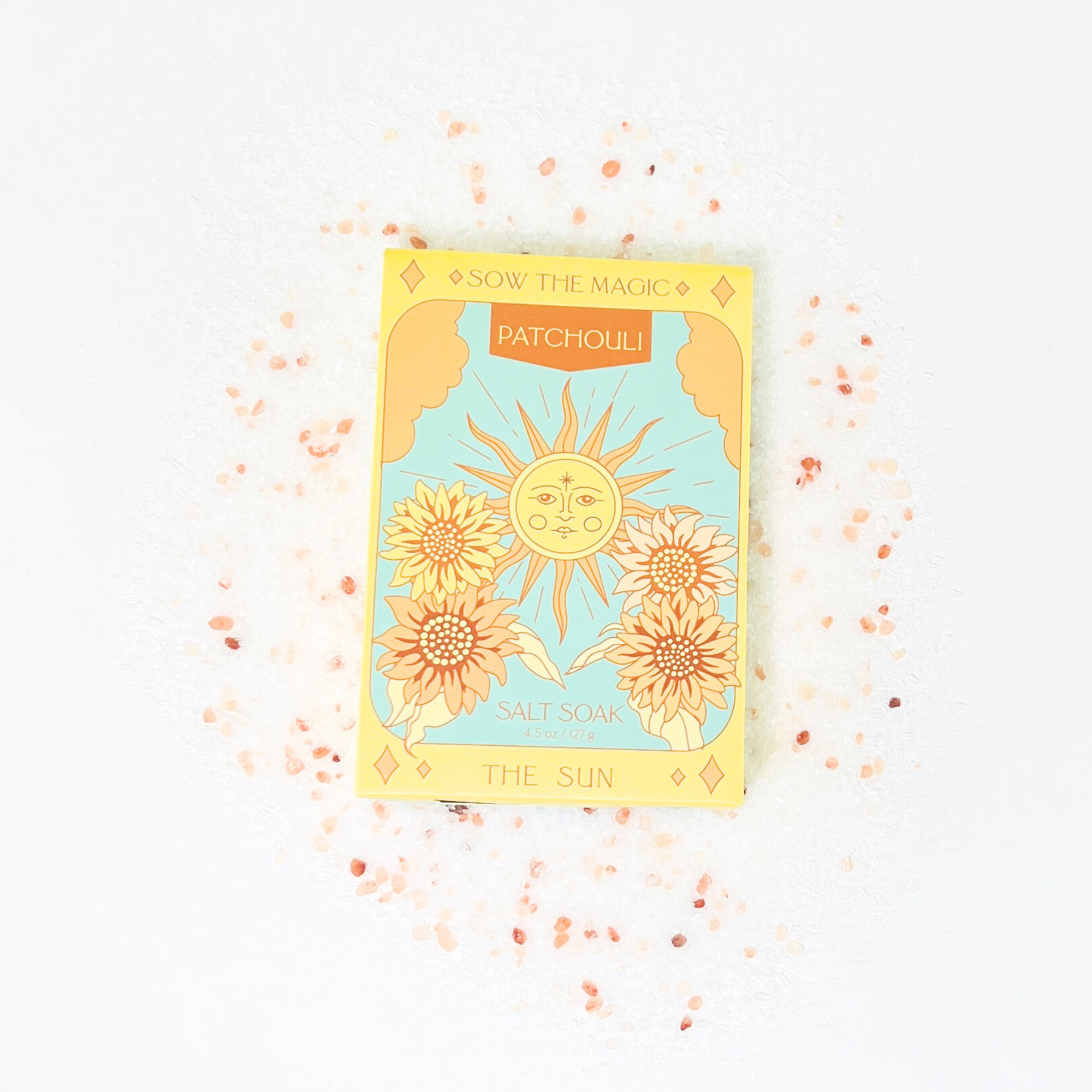 Decorative soap packaging with sun design and text on a light background