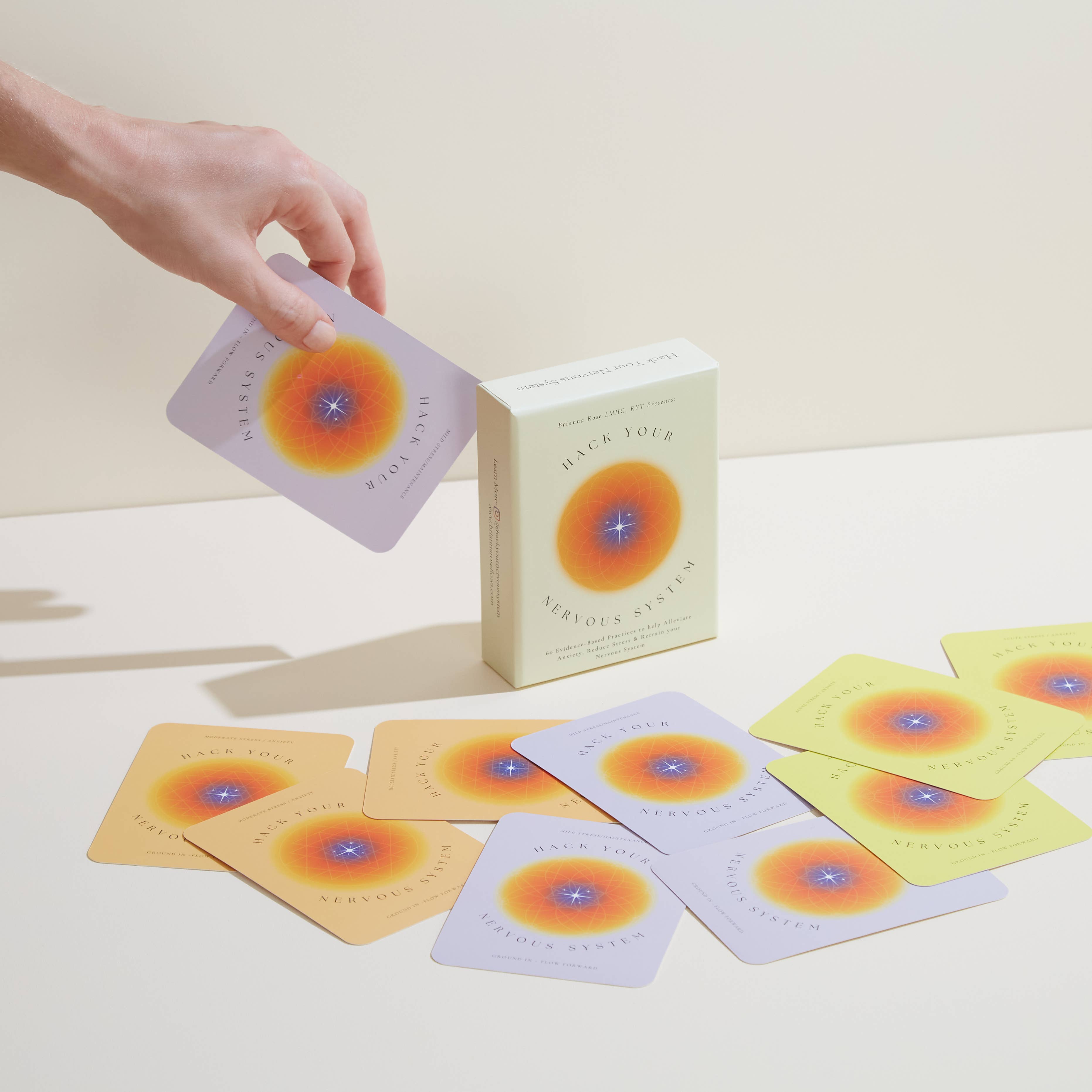 Card game with colorful cards and a box on a light surface