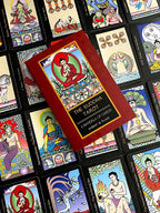 Collection of tarot cards featuring Buddha illustrations with a book titled 'The Buddha Tarot' on top.