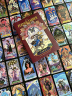 Zervos Tarot book surrounded by tarot cards with intricate artwork