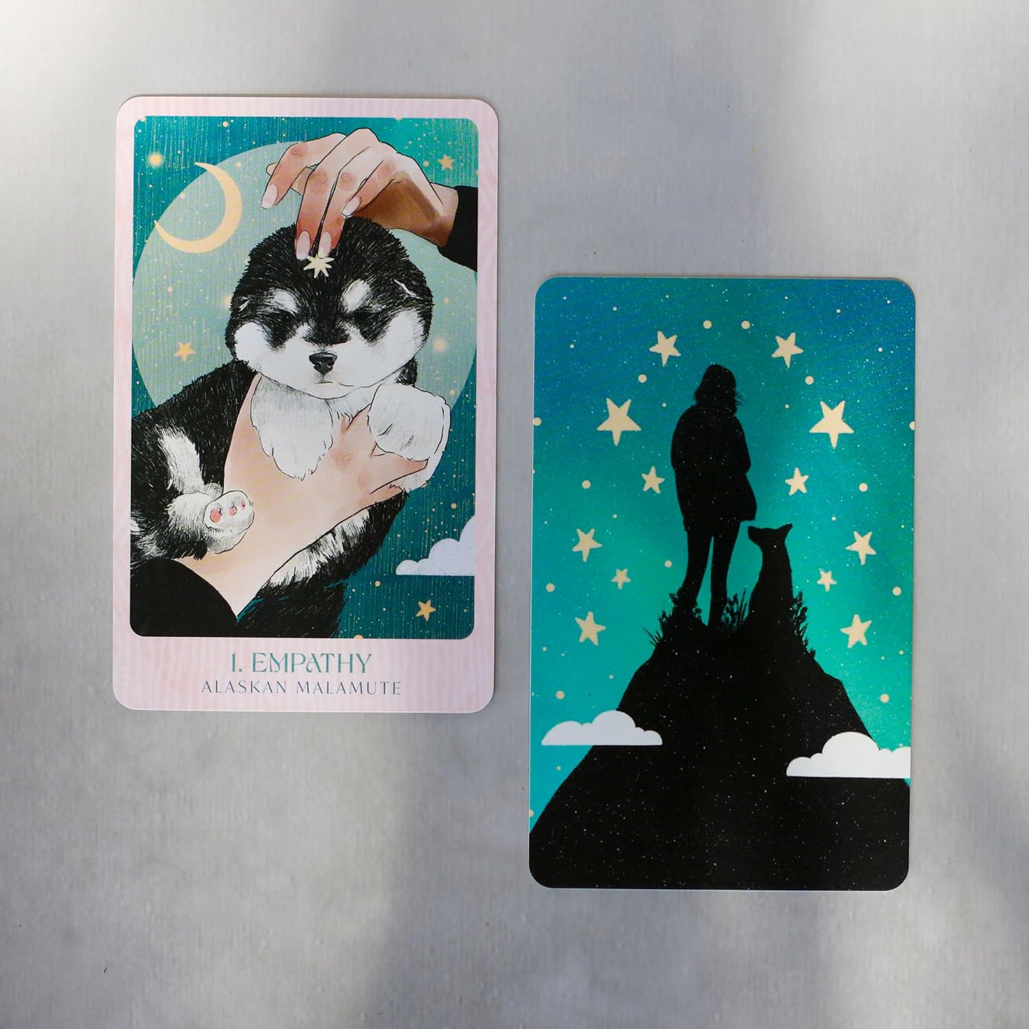 Two tarot cards featuring a dog and a silhouette of a person with a dog against a starry night sky.