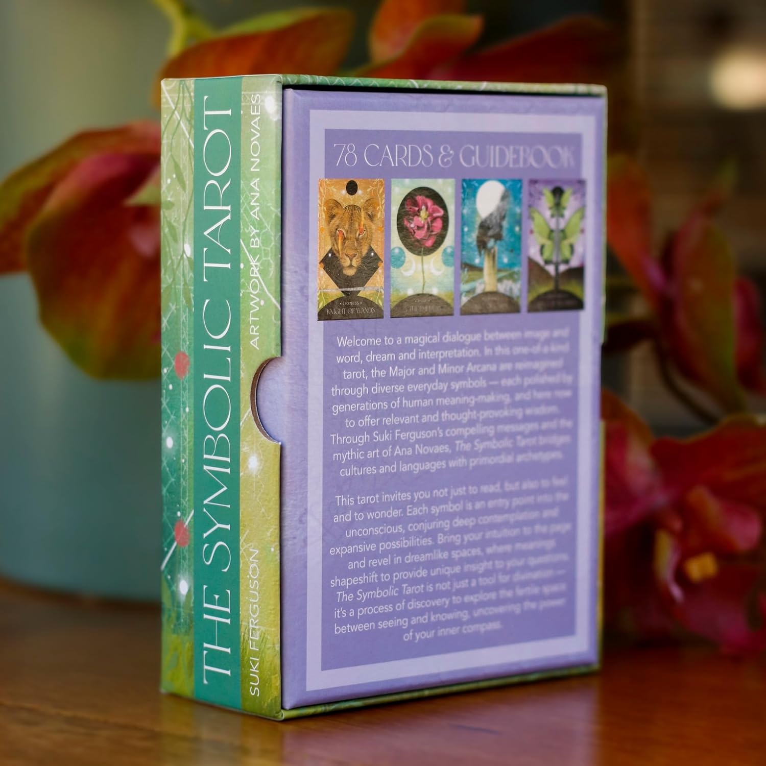 Box of 'The Symbolic Tarot' with colorful tarot card illustrations on a wooden surface.