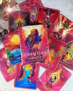 A spread of colorful oracle cards from the Rising Rani Oracle deck, featuring vibrant illustrations and titles such as Patience, Flow, and Karma, arranged on a light textured surface.