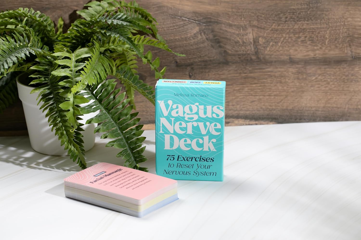 Vagus Nerve Deck book with flashcards on a wooden surface with a plant in the background