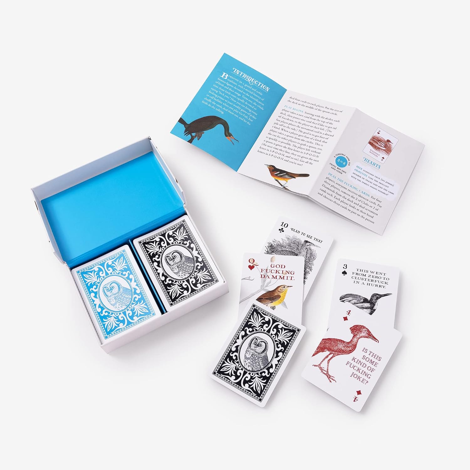A bird-themed card game set displayed on a light gray background, including an open box with blue interior and card backs, an open instruction booklet, and several illustrated cards showing different birds.