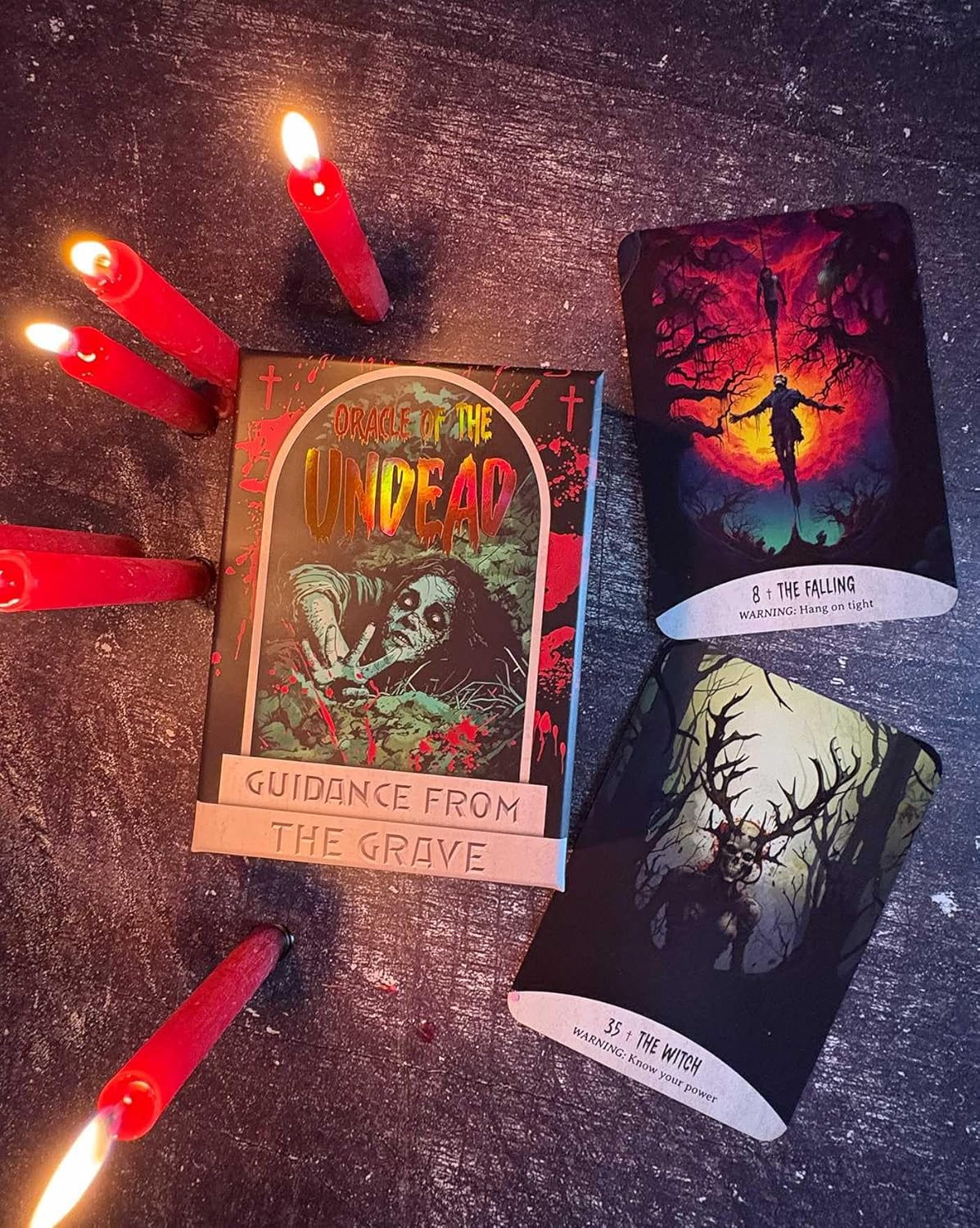 Witchy cards with red candles on a dark surface