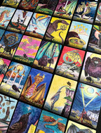 Collection of tarot cards with various designs and symbols
