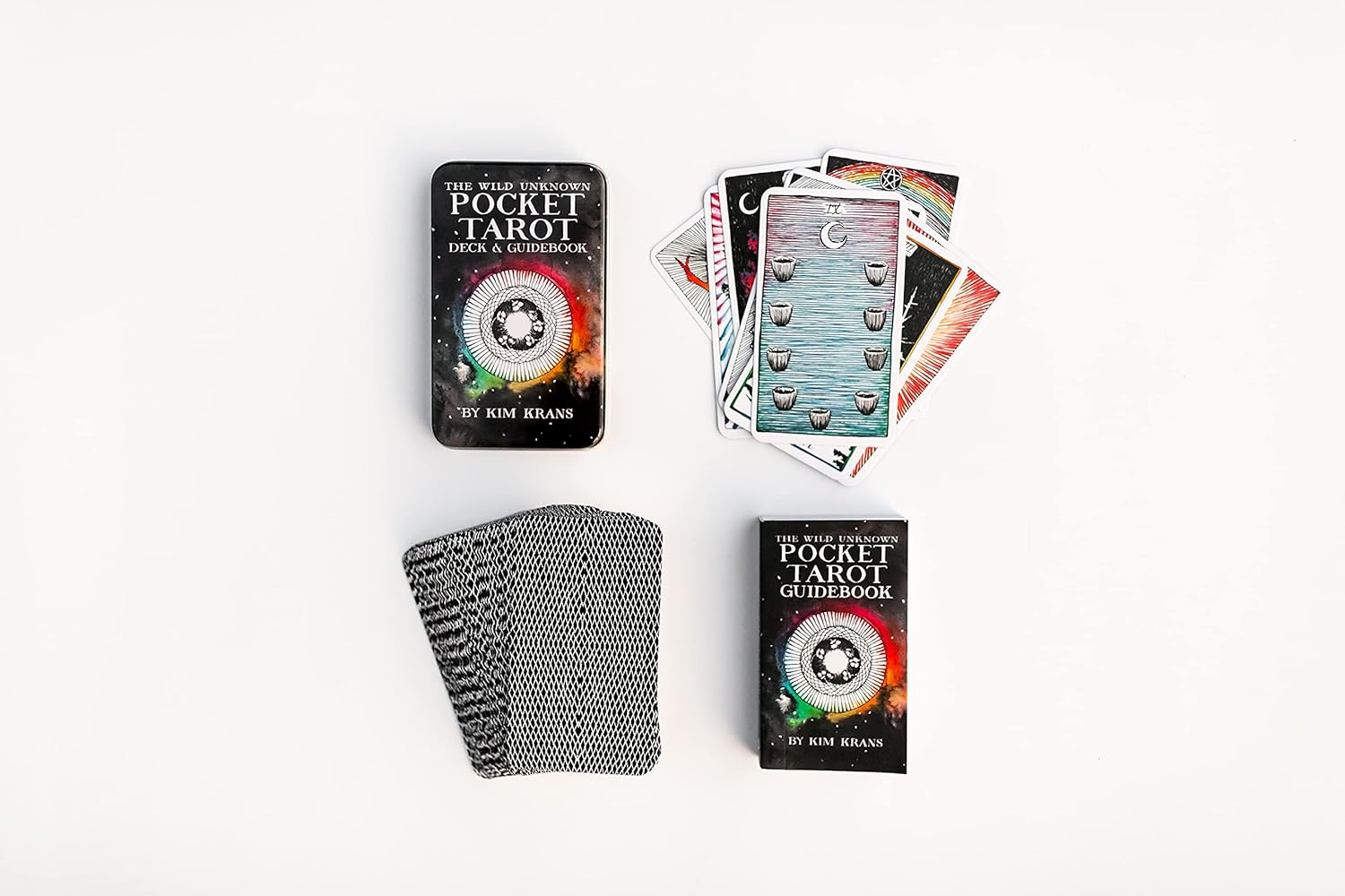 Pocket Tarot cards with two books on a white background