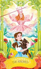 Illustration of a fairy in a pink dress with a wand, Dorothy in a blue dress holding a dog, and a green border with flowers.