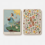 Two tarot cards, one featuring 'The Fool' with a woman in a garden and the other with floral and nature-themed design.